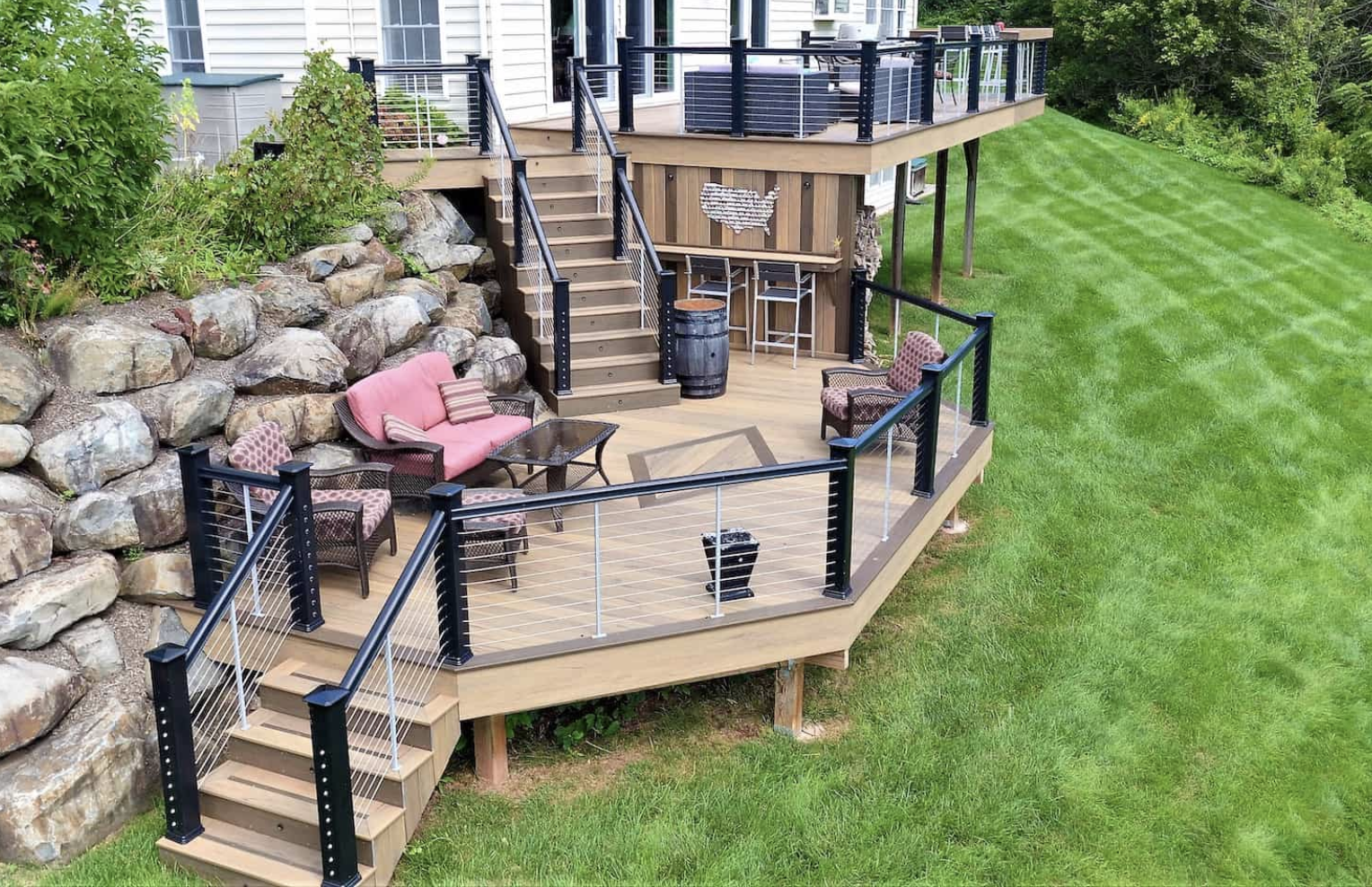 A multi-level backyard deck with outdoor furniture.