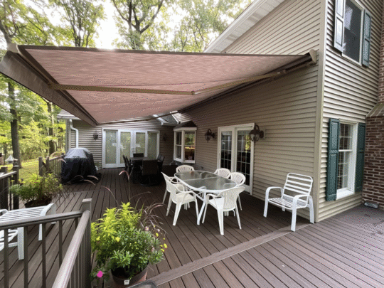 A Sunesta retractable awning over a deck with outdoor furniture.